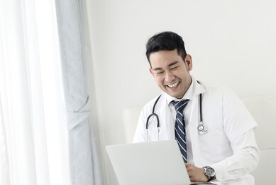 asian doctor using laptop with idea lifestyle concept.