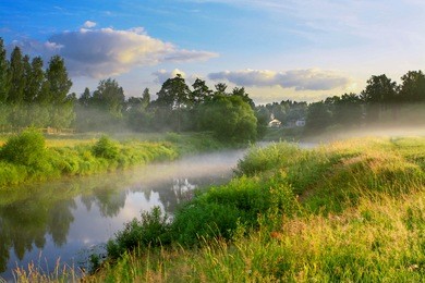 summer sunrise over the river with a fog