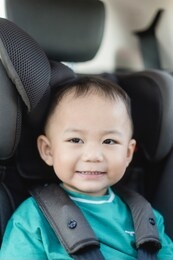transport, safety, childhood road trip and people concept - happy baby boy sitting in baby car seat or booster seat, child in auto baby seat in car, asian boy in summer vacation to travel with family.