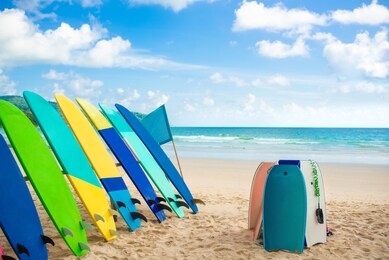 colorful surfboards on tropical beach at phuket thailand and bule sky