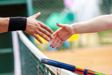 tennis players shake hands after match closeup.
