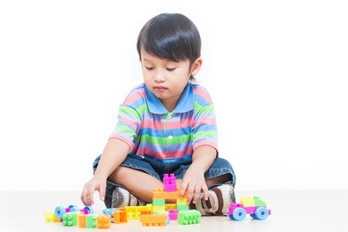 cute boy playing lego 