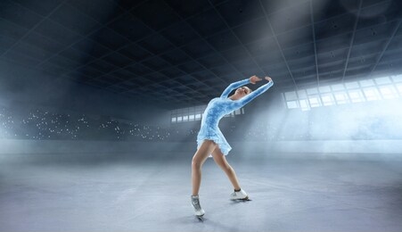 figure skating girl in professional ice arena.