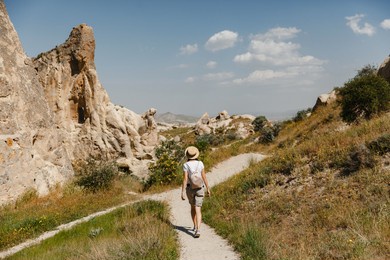 girl tourist at the top of the mountain enjoying the beautiful view of the valley in cappadocia. happy travelling in turkey concept