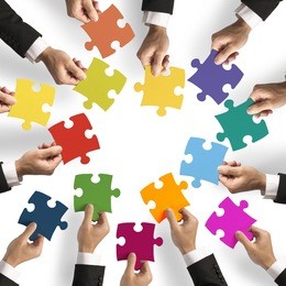 teamwork and integration concept with puzzle pieces