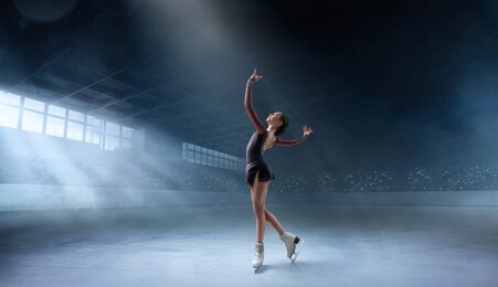 figure skating couple in professional ice arena.