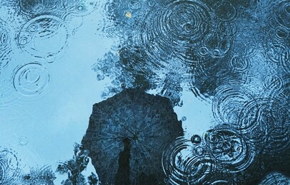 reflection umbrella in puddle background. abstract rain backdrop. soft selective focus