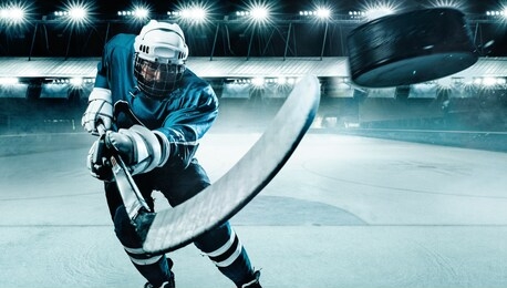 ice hockey player athlete in the helmet and gloves on stadium with stick. action shot. sport concept.