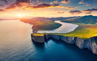 view from flying drone. breathtaking evening scene of sorvagsvatn lake, vagar, faroe islands, kingdom of denmark, europe. unbelievable summer sunset on atlantic ocean.