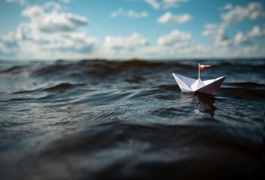 small paper boat in big waves