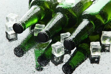 bottles of beer with ice cubes, close up