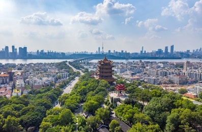the yellow crane tower , located on snake hill in wuhan, is one of the three famous towers south of yangtze river,china.4 chinese letters on tower is "nang xiong gao gong" means "amazing heaven"