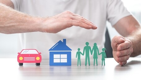 family, house and car protected by hands - concept of life, home and auto insurance