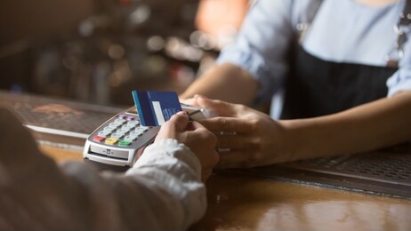 contactless payment concept, female customer holding credit card near nfc technology on counter, client make transaction pay bill on terminal rfid cashier machine in restaurant store, close up view