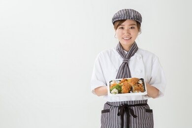 woman cook holding a box with food 