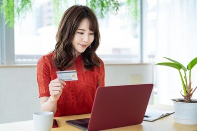 attractive asian woman using a credit card. online shopping.