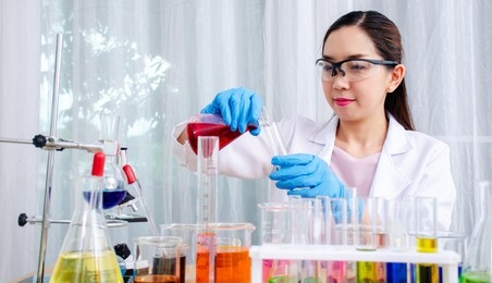 scientist beautiful woman research and drop medical chemicals sample in test tube at laboratory, science, chemistry, technology, biology concept