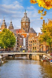 canal and st. nicolas church in amsterdam, the netherlands