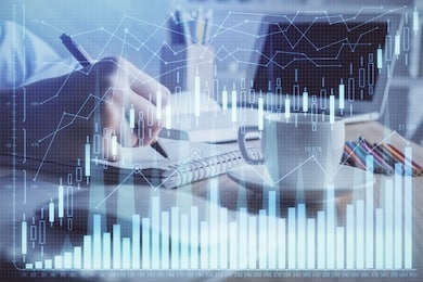 financial chart drawn over hands taking notes background. concept of research. double exposure