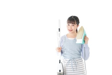 young housewife doing housework with smile