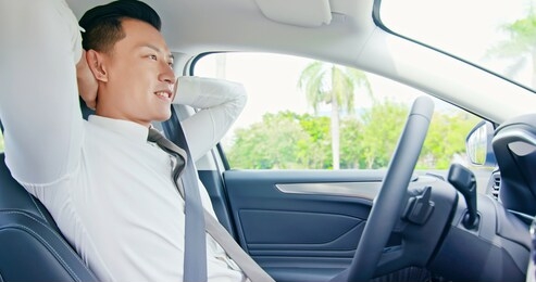 confident business asian man enjoy to drive an self-driving smart car
