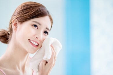 beauty asian girl clean her face with towel in the bathroom