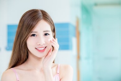 beauty skin care woman apply cream on her face