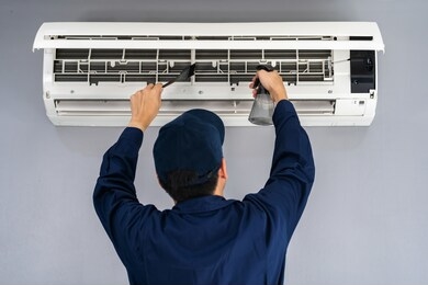technician service cleaning the air conditioner indoors