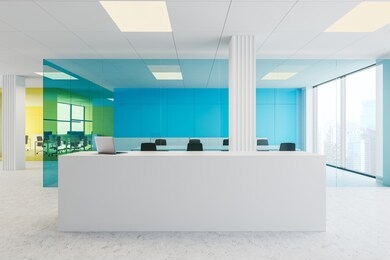 interior of modern office with blue and yellow glass walls, concrete floor, white reception desk with laptop, meeting room and open space area. 3d rendering
