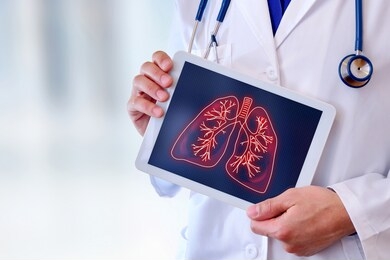 doctor showing a picture of lungs on a tablet in a hospital. horizontal composition.