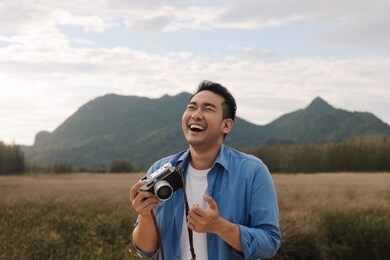 asian man backpacker travel in the nature park on his vacation ,happy traveler man concept.