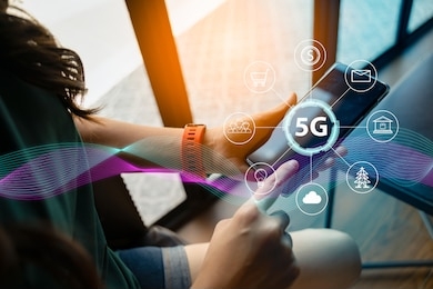 close up of female hand holding a phone with a 5g hologram in coffee shop. 5g network wireless systems.the concept of 5g network, high-speed mobile internet, new generation networks.