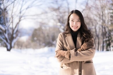portrait young beautiful asian woman smile happy travel and enjoy with snow winter season in hokkaido sapporo japan