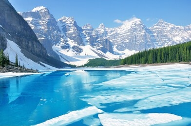 moraine lake under the ice at morning spring time. banff national park. canada.