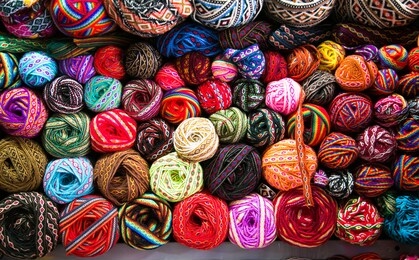 knitting needles, colorful threads. knitting pattern of colorful yarn wool on shopfront. knitting background. knitting yarn for handmade winter clothes. cusco , peru, south america. 