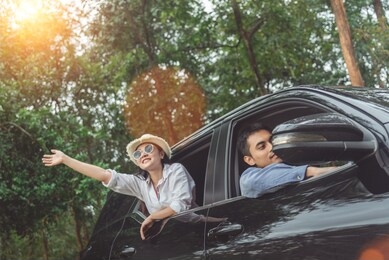 happy asian young travellers with drive car off road in forest