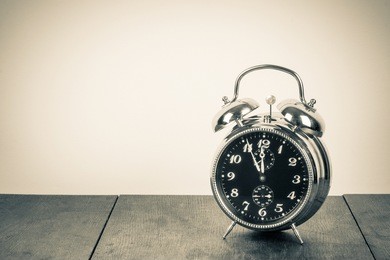 vintage background with retro alarm clock on table
