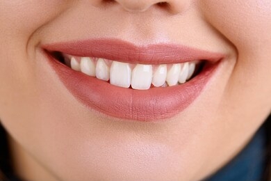 closeup beautiful young woman smile. dental health. teeth whitening.  restoration concept