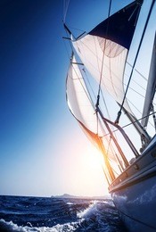 sail boat in action, summer adventure, luxury water transport, sunset light, active lifestyle, recreation in the sea, travel and tourism concept 