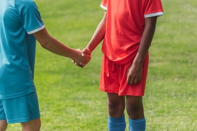 cropped view of multicultural kids shaking hands 