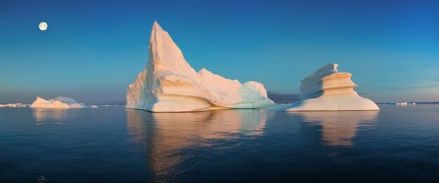 iceberg at sunset. nature and landscapes of greenland. disko bay. west greenland.
summer midnight sun and icebergs.
big blue ice in icefjord. affected by climate change and global warming.