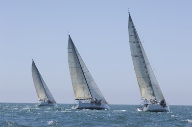 view of three yachts compete in team sailing event
