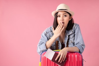 tourist woman in summer casual clothes.asian smiling woman .passenger traveling abroad to travel on pink background.asian woman going to summer vacation.travel trip funny.