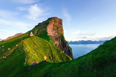 kallur lighthouse on green hills of kalsoy island, faroe islands, denmark. landscape photography