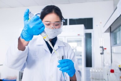 interior of clean modern white medical or chemistry laboratory background. laboratory scientist working at a lab with micro pipette and test tubes. laboratory concept with asian woman chemist.