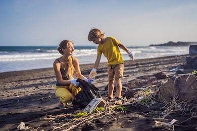 mother and son are cleaning up the beach. natural education of children