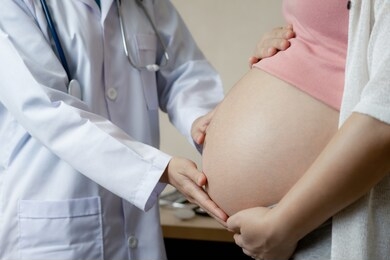 happy pregnant woman visit gynecologist doctor at hospital or medical clinic for pregnancy consultant. doctor examine pregnant belly for baby and mother healthcare check up. gynecology concept.