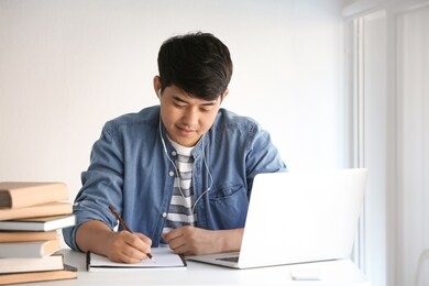 asian student preparing for exam at home