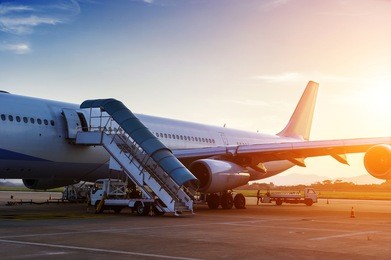 airplane near the terminal in an airport at the sunset