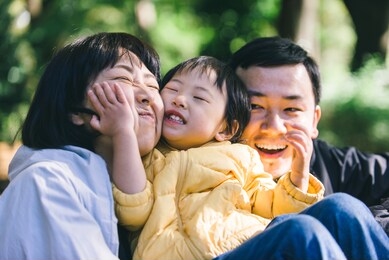 happy and playful japanese family in a park in tokyo